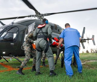 Samaritan’s Purse medical staff meet a patient transported by military helicopter.