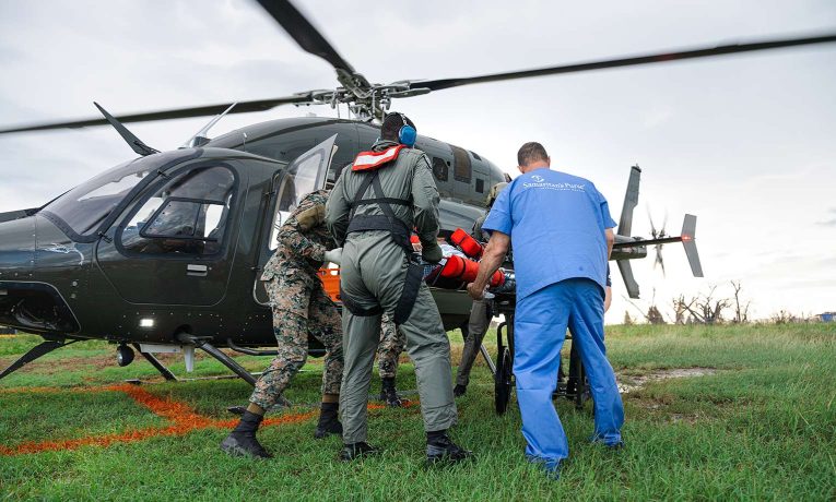 Samaritan’s Purse medical staff meet a patient transported by military helicopter.