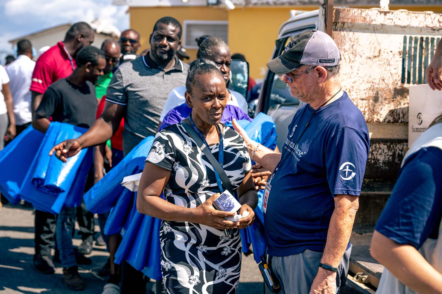 Samaritan’s Purse DART member Peter listens to and prays with residents as they receive emergency aid.