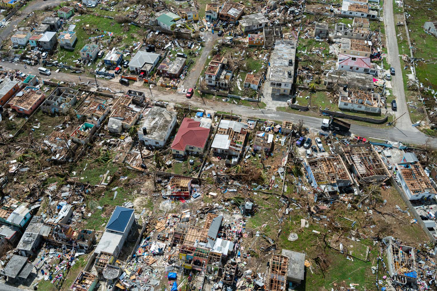 Aerial view of destroyed homes and debris-strewn streets in Black River, Jamaica, after Hurricane Melissa.