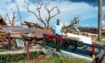 A man stands among the splintered remains of his home in Black River, Jamaica, after Hurricane Melissa destroyed the area.