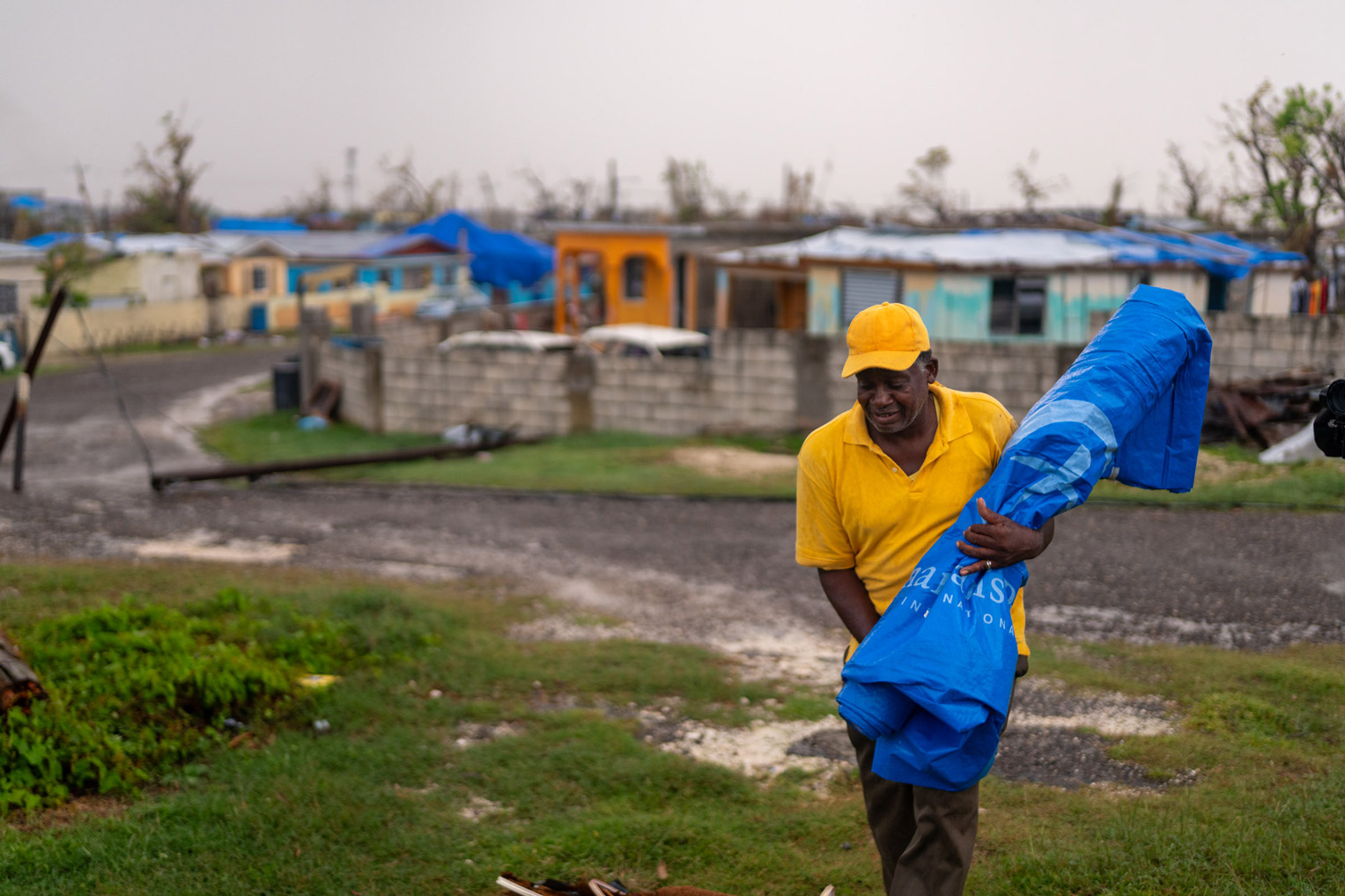 The large section of Samaritan's Purse shelter tarp allowed Derick a dry place to sleep in his roofless home. Repairing what Melissa destroyed could be many months from now.