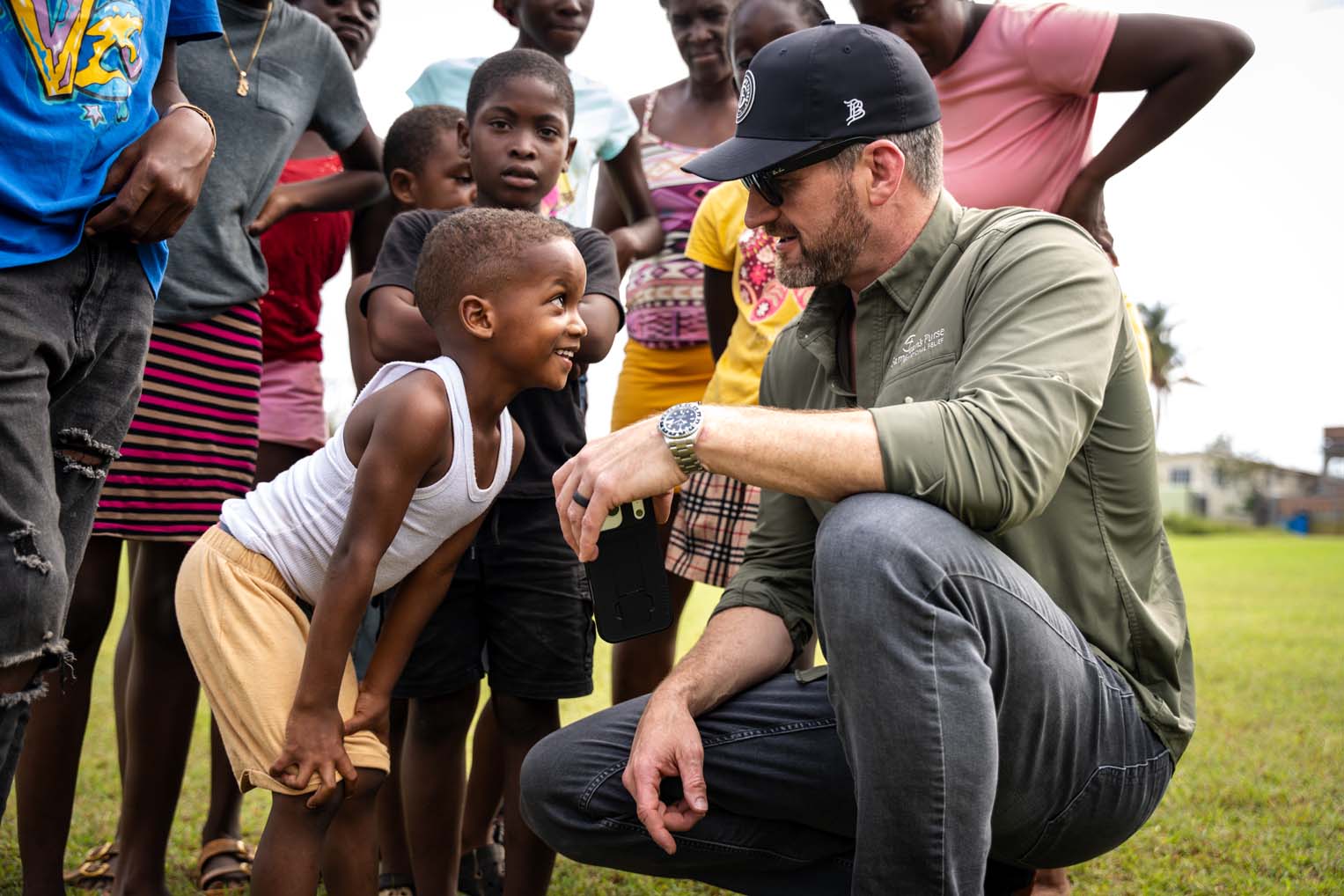 Children from Black River joyfully greet Graham during his visit to distribution areas.