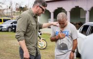 Samaritan's Purse COO prays with a resident of southwest Jamaica.