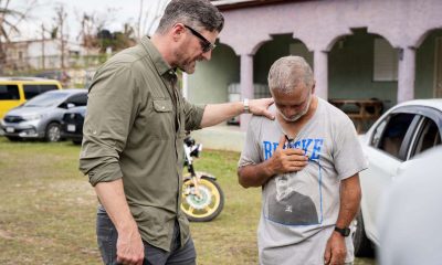 Samaritan's Purse COO prays with a resident of southwest Jamaica.