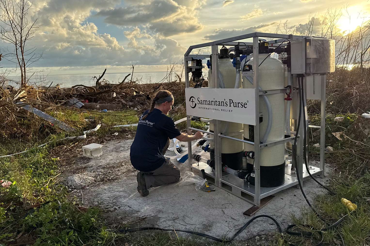 Two Samaritan’s Purse team members set up a water filtration system in Jamaica after Hurricane Melissa.