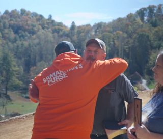 A Samaritan’s Purse rebuild team member welcomes the Murphys to their new home in Burnsville during a special time of prayer and encouragement. Their mobile home was destroyed during Hurricane Helene.