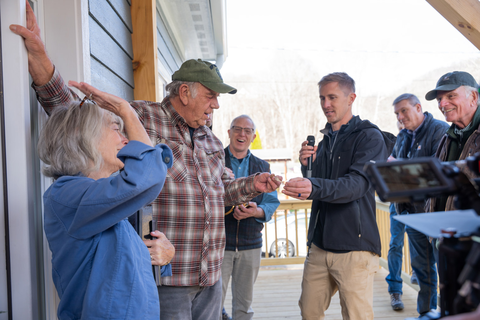 Rebuild staff member John Granger, foreman on the Tatum home, presents the Tatums with keys to their house.