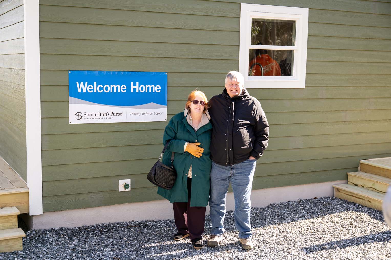 Scott and Meta stand outside their new home, grateful for a fresh start after Hurricane Helene destroyed everything they had planned for retirement.