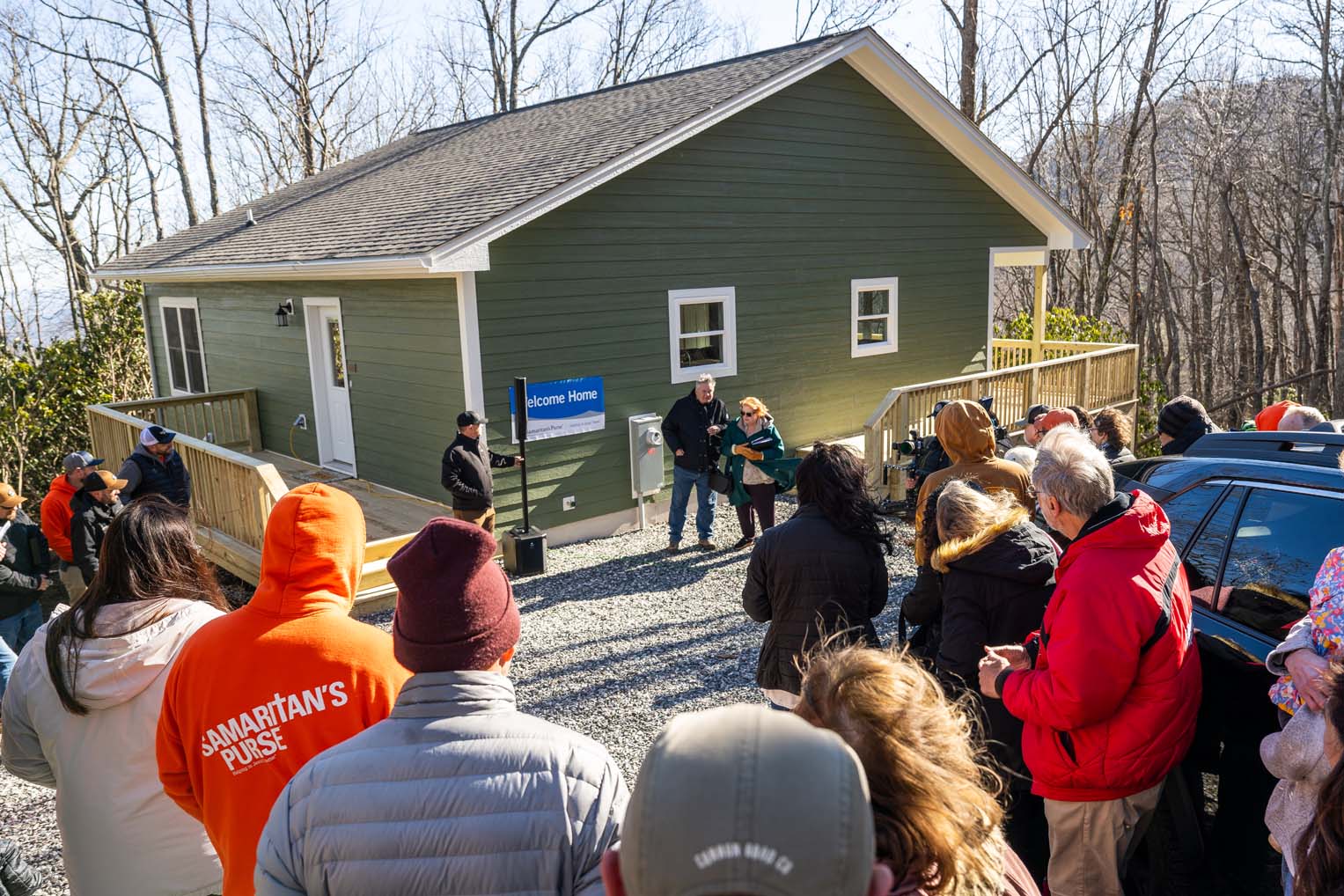Family, friends, volunteers, and staff celebrate the couple’s new home and thank God for His provision.