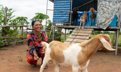 A woman in Cambodia smiling because of the gift of goats to help support her family.