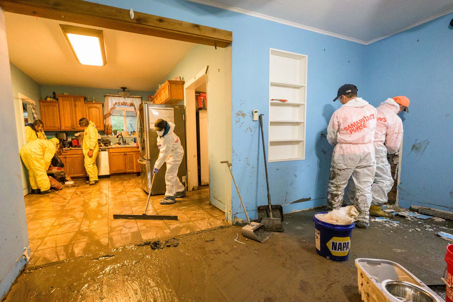 Samaritan’s Purse volunteers worked shoulder to shoulder—scraping floors, tearing out soaked drywall, and hauling debris from room to room.