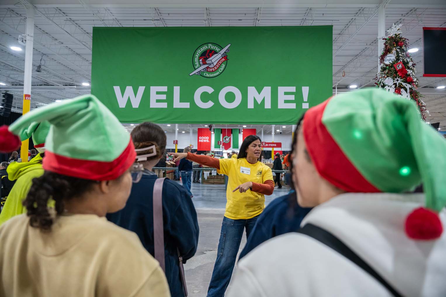 2595US -B1-465 Volunteers brought their holiday cheer as work continues preparing shoebox gifts.