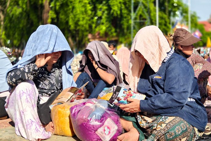 Women read through "The Jesus Story" booklet provided by Samaritan's Purse, that explains the Gospel in a clear way in Khmer, their heart language.