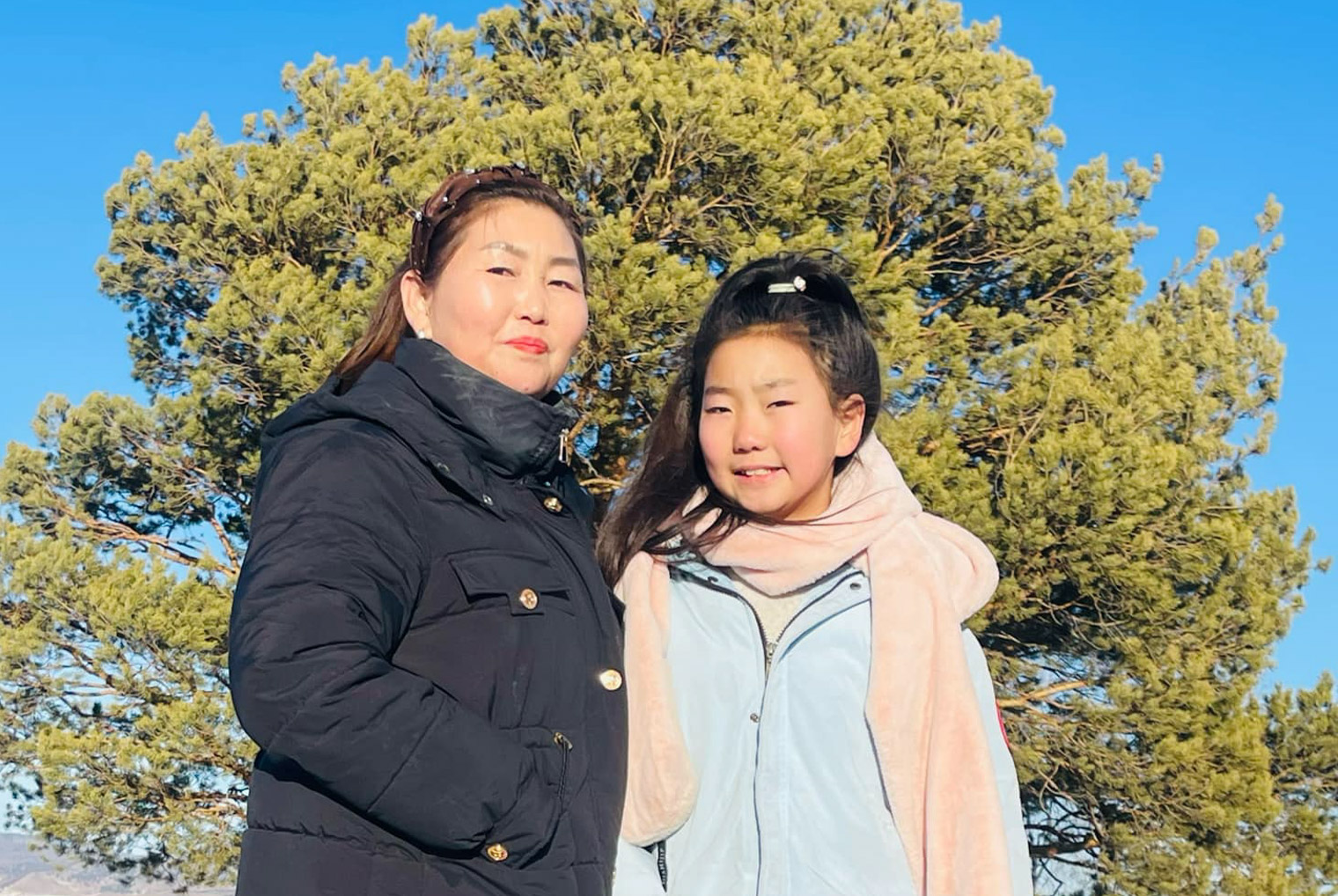 Khuslen and Egiimaa pose for a picture amid a dusting of snow in the Mongolian countryside.