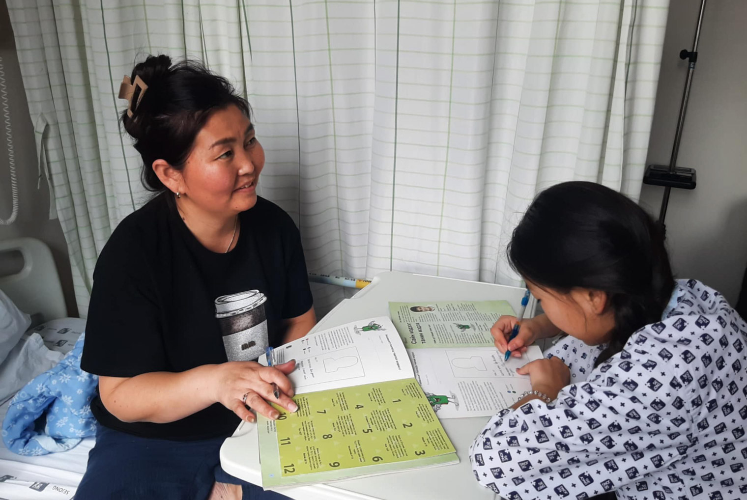 Khuslen answers questions in The Greatest Journey booklet that one of our Children’s Heart Project interpreters led her through during Khuslen’s hospital stay.