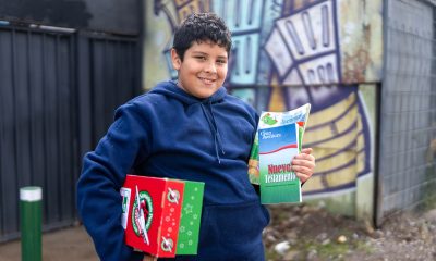 boy in Chile with shoebox and The Greatest Journey materials