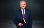 Franklin Graham stands ready with Bible in hand.