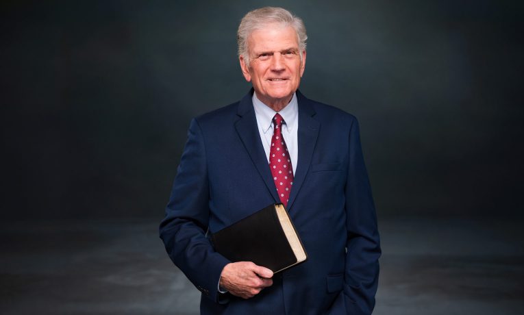 Franklin Graham stands ready with Bible in hand.