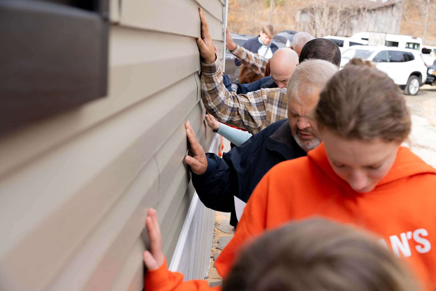 Friends, family, and Samaritan's Purse staff and volunteers joined in prayer over the new home.