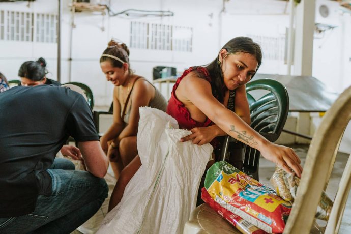 Each large white bag contains rice, pasta, flour, oats, canned tuna, beans, lentils, and cooking basics like oil and salt to sustain a family for a month.  Families receive a bag for three consecutive months, alleviating the daily stress to find food for themselves.