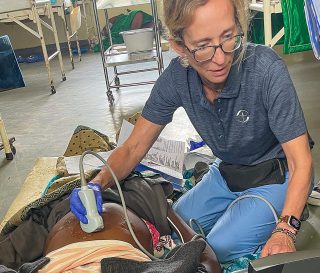 Susan Hopkins performs an ultrasound on an expectant mother at Karanda Hospital in Zimbabwe.
