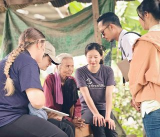 Samaritan's Purse staff pray with blind woman in Cambodia
