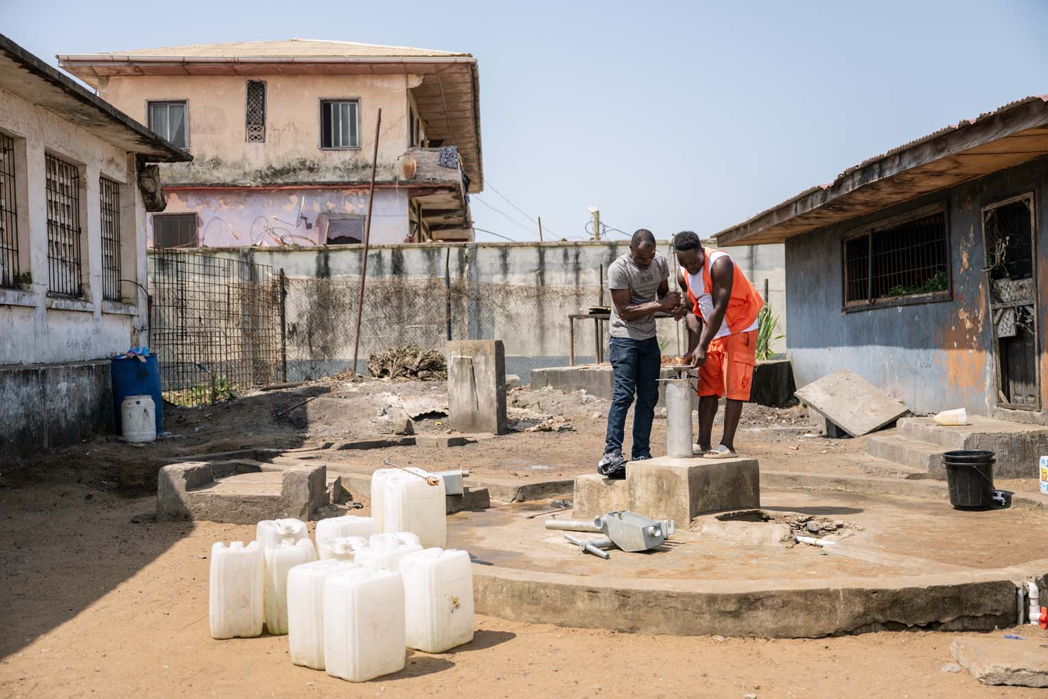 Prince helps with a well maintenance project repairing the hand pump.