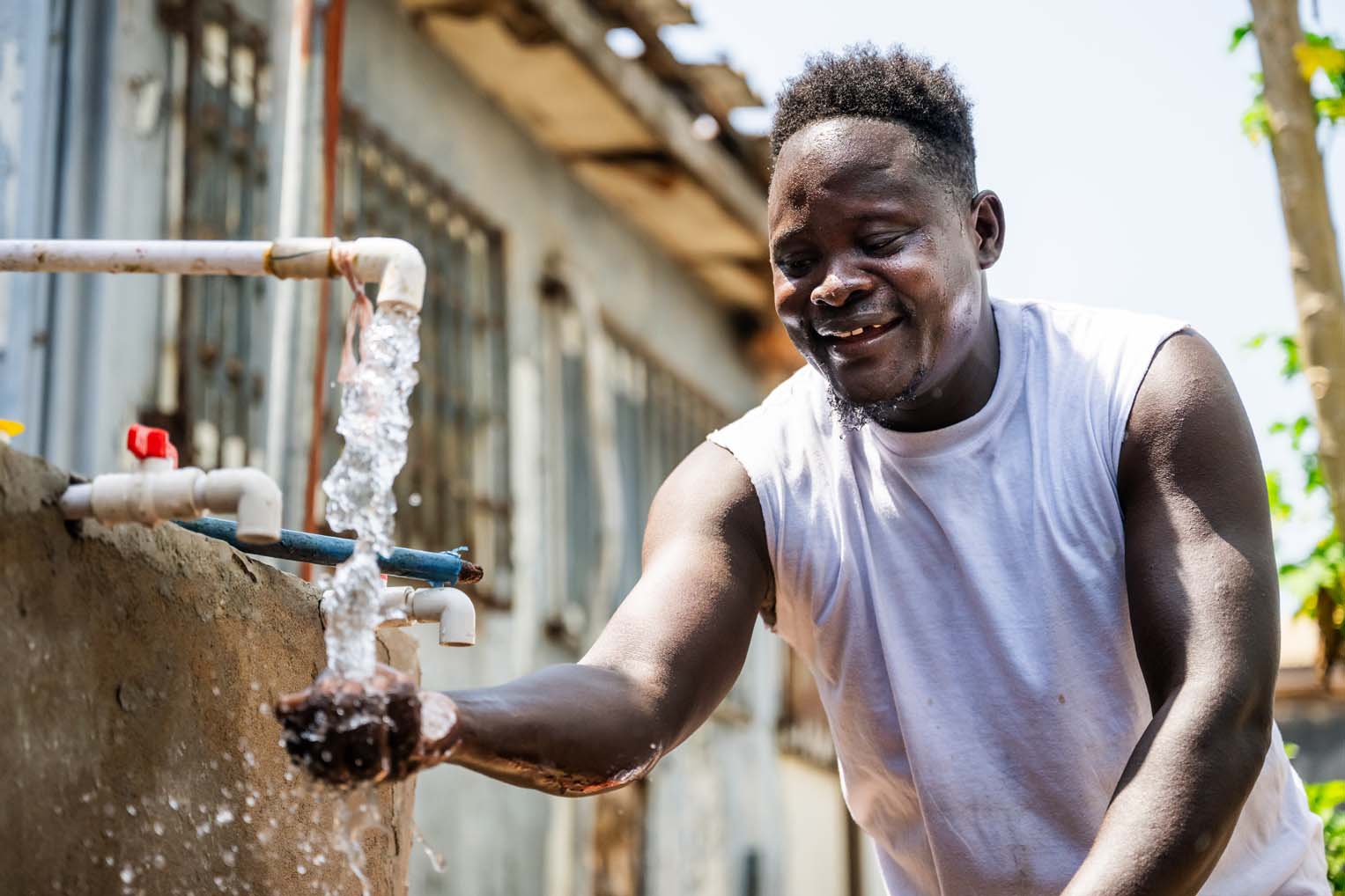 Prince enjoys the gift of clean water provided through his handiwork.