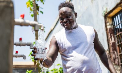Liberian inmate fills his bottle with clean drinking water from a system provided by Samaritan's Purse at Monrovia Central Prison.