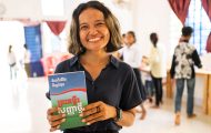 Cambodian volunteer with Cambodian Bible given to graduates of The Greatest Journey