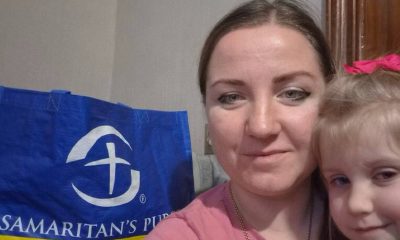 Yana and her daughter with a bag of groceries from Samaritan's Purse