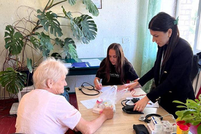 Maria receiving medication from the Mobile Medical Unit