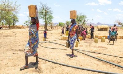 In Sudan, women carry jerry cans full of water from Samaritan's Purse wells to their homes.