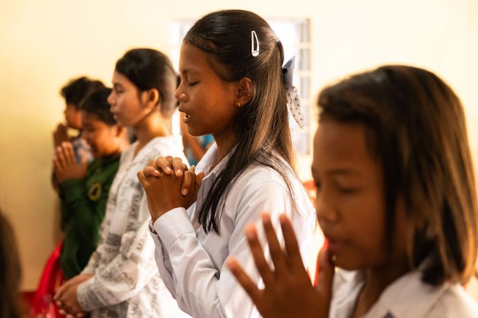 Chea prays in The Greatest Journey class