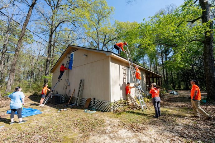 Beyond clearing fallen trees from homeowners' yards, the team patched holes in the roofs left by the ice storm with durable tarp. 