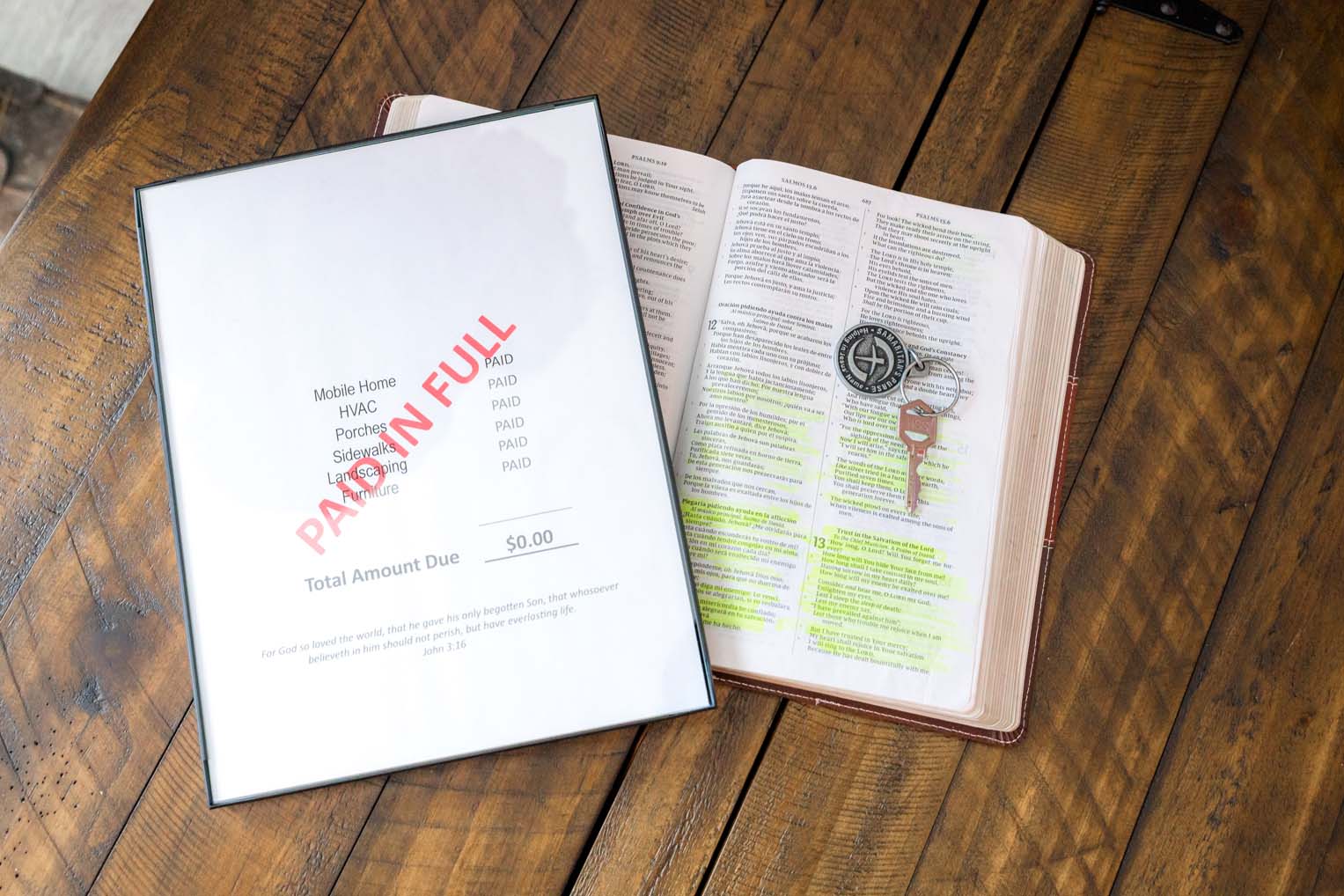 In addition to keys, homeowners receive a special Bible signed by the team and a Paid in Full invoice to remind homeowners of how Jesus’ blood shed on the cross covers the debt of sin.