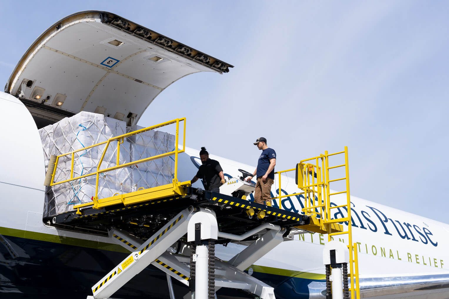 Team members load 767 aircraft