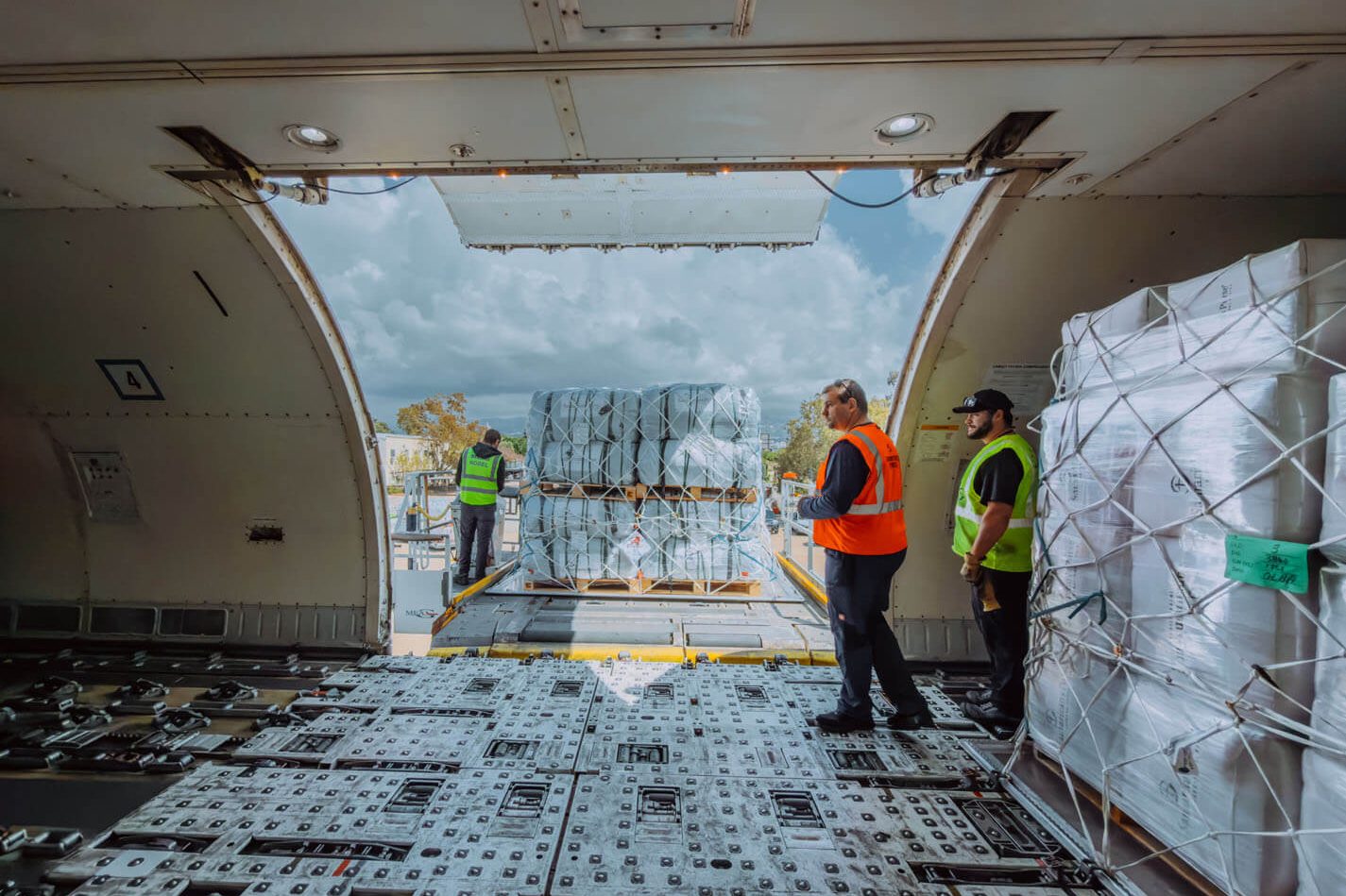 Inside of cargo plane with pallets being offloaded