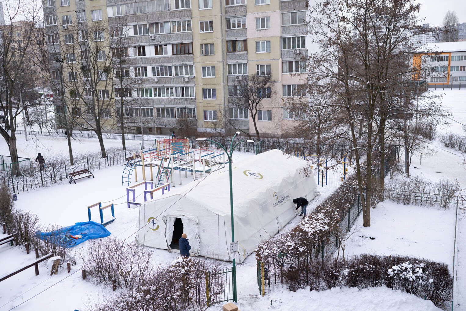 aerial view of warming center tent in snow covered Ukraine