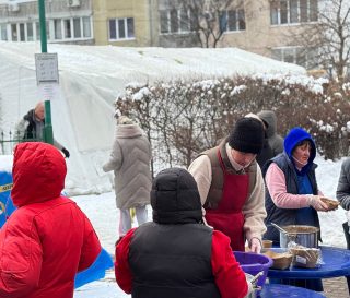 Food distribution outside tent in Kyiv
