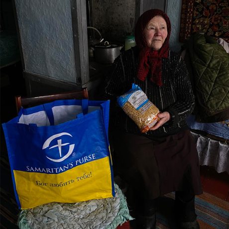 Hanna holds bag of pasta that she got from a larger bag of groceries from Samaritan's Purse