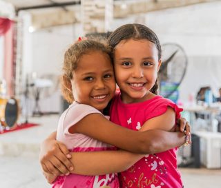Two girls hugging.