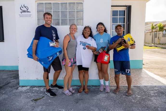 Loida (center) thanks God for Samaritan's Purse, and Pastor Chad (far left) and his wife, Angela (middle left). Each generator distributed comes with a power block, 100-foot extension cord, gas can, and engine oil. 