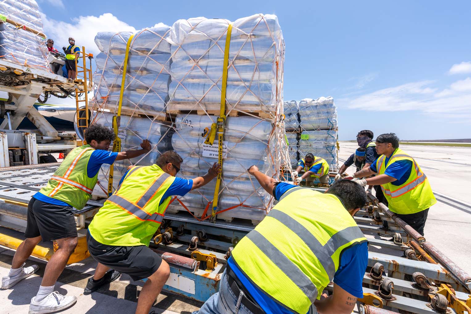 Crews offload many tons of supplies from a second airlift to the islands.