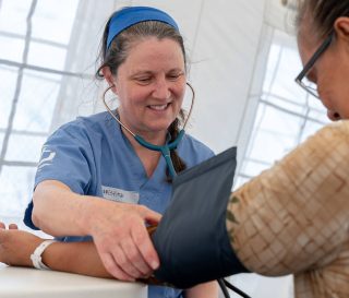 Medical teams with Samaritan's Purse assist a patient in the Mariana Islands near Saipan as we begin to care for residents at out outpatient and mobile clinics.