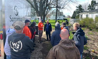 Volunteers present a special Billy Graham Training Center Bible and pray with a homeowner in Lena.