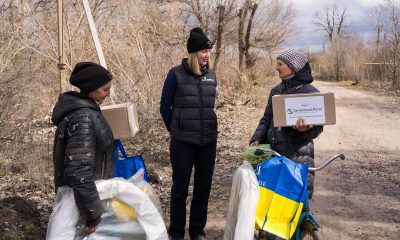 Samaritan's Purse staff visit with Vira and provide her with agricultural supplies