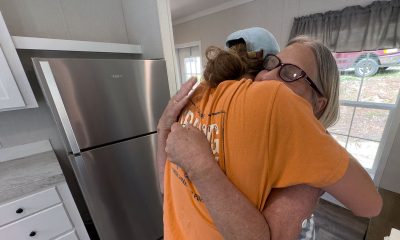 Andrea Green embraces a Samaritan's Purse rebuild team member as she celebrates her new home.