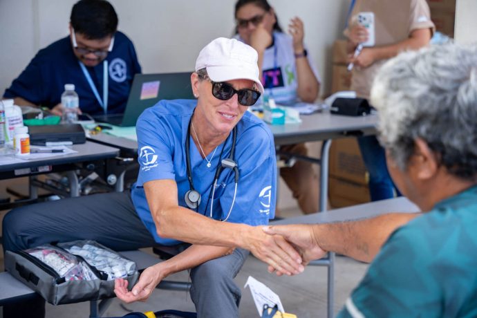 mobile medical unit practitioner shakes the hand of a patient